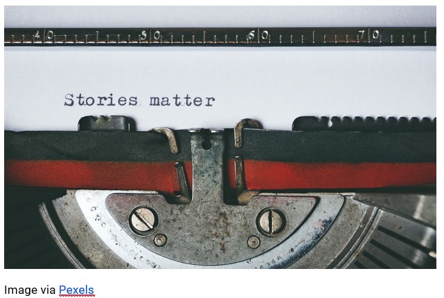 An old fashioned typewriter with a piece of paper and "stories matter" typed on it
